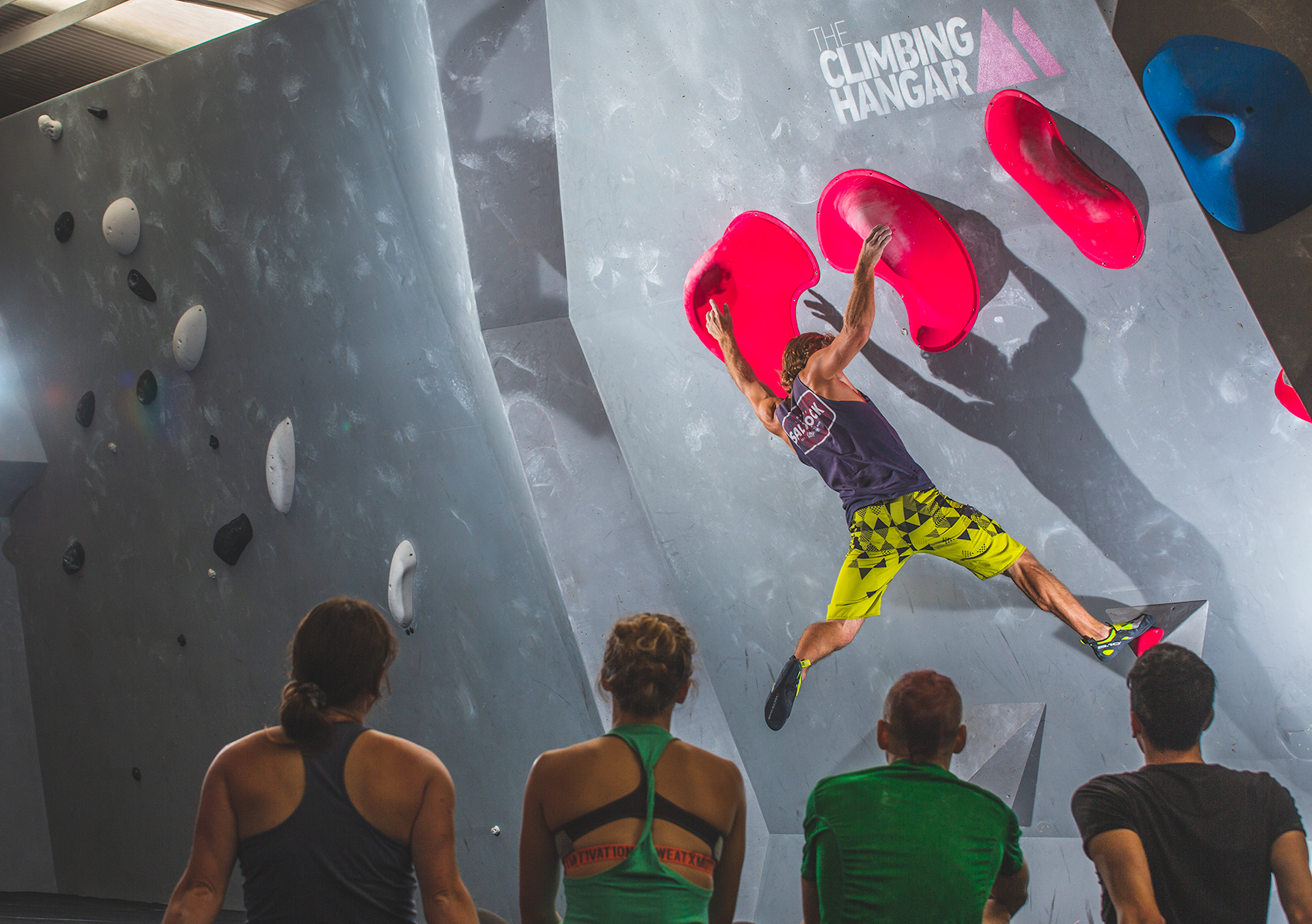 A group of climbers at a climbing wall