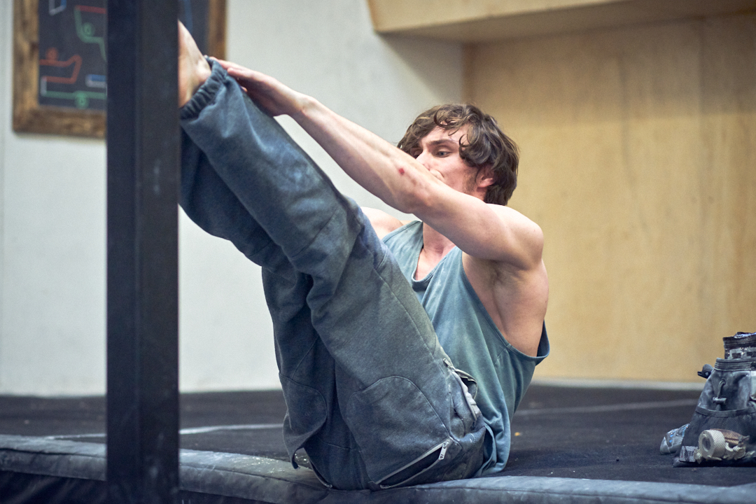 A man training core at a climbing gym