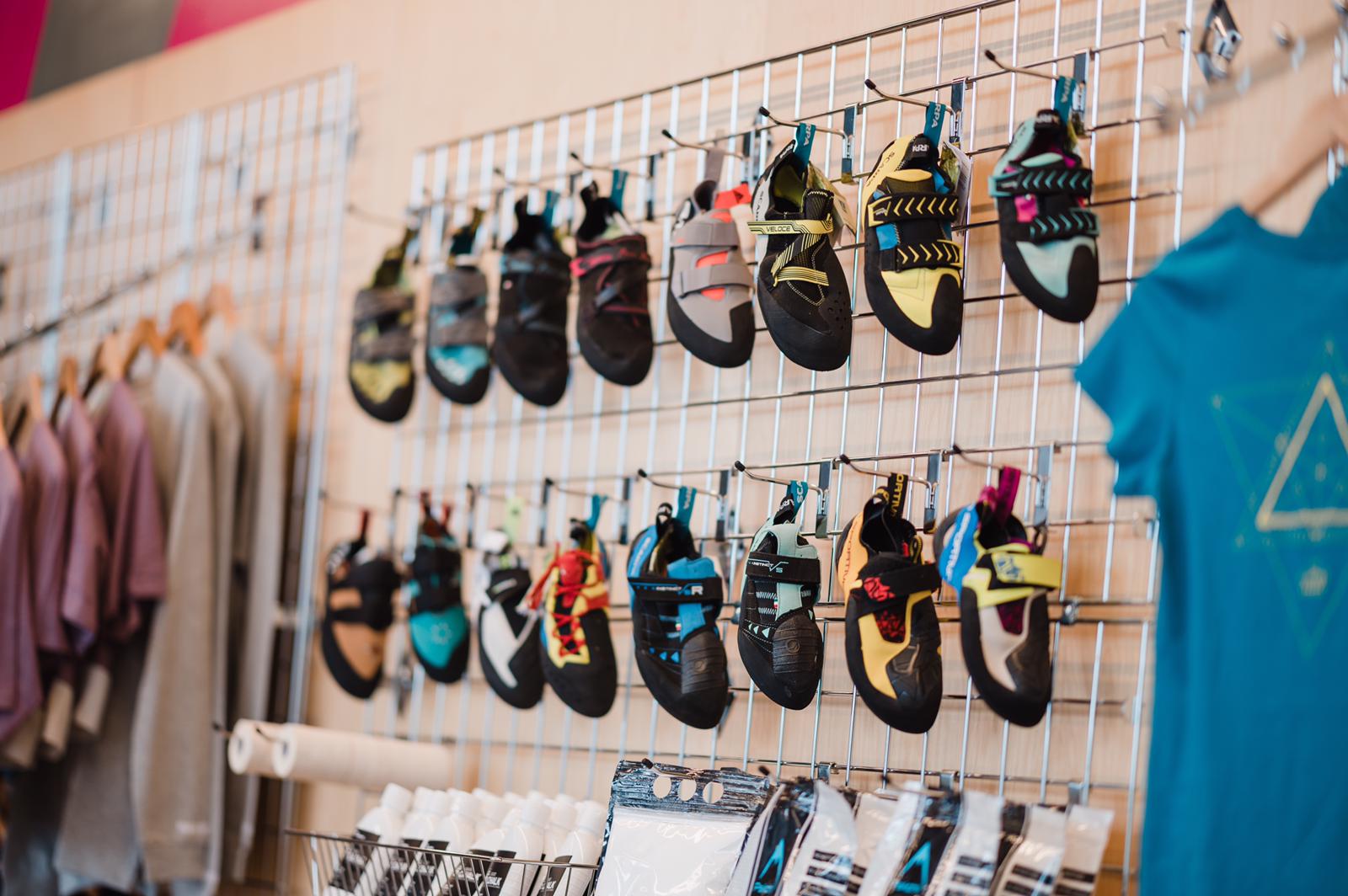 A range of climbing shoes displayed on a wall