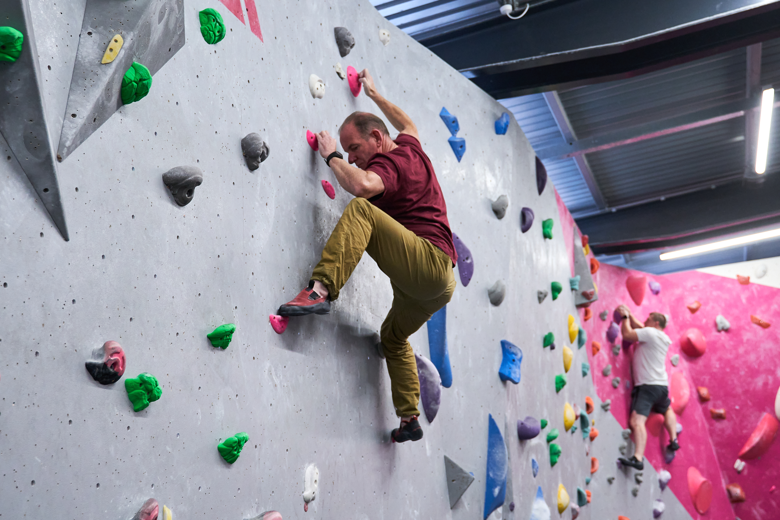 A climber being precise with his footwork on a climbing wall