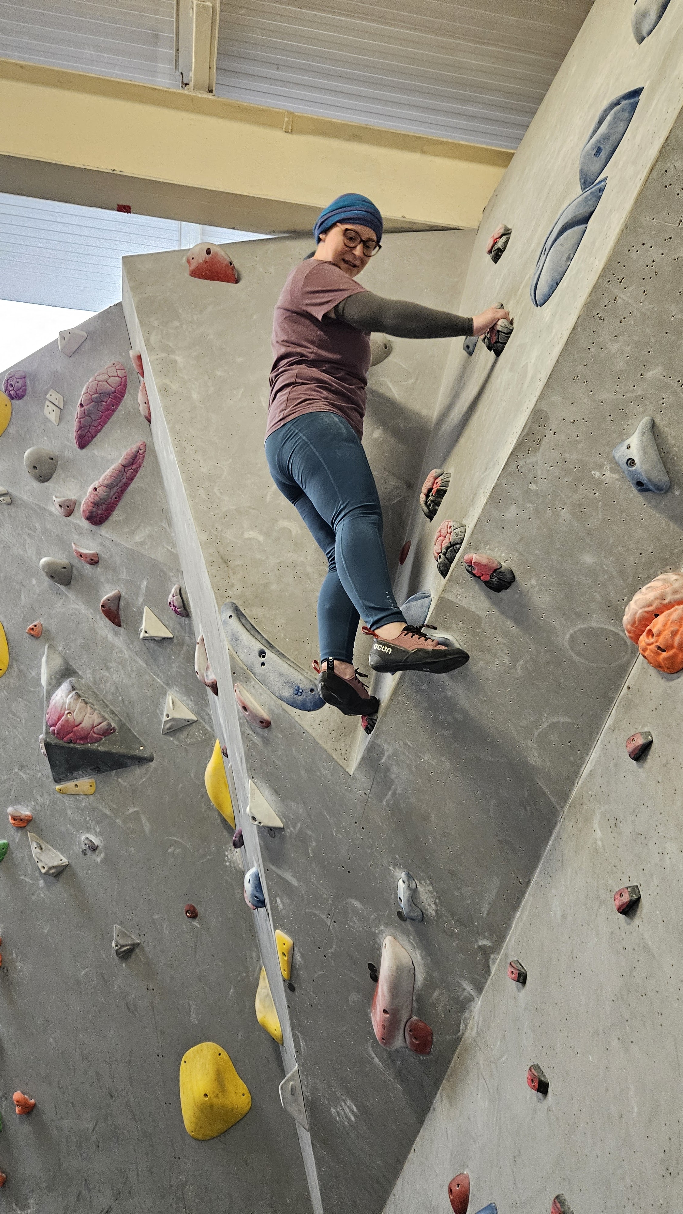 A female climber on a bouldering wall