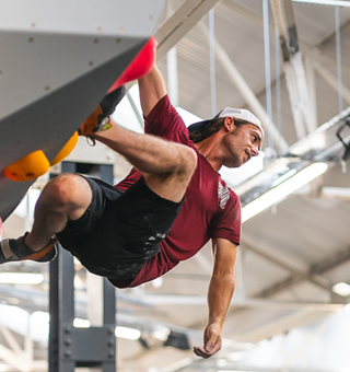 A guy bouldering at The Climbing Hangar